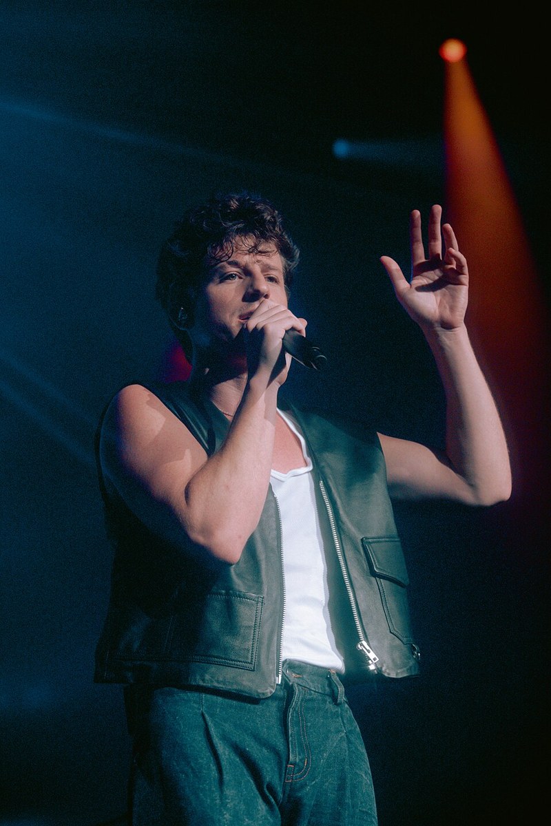Charlie Puth performing on stage at a concert