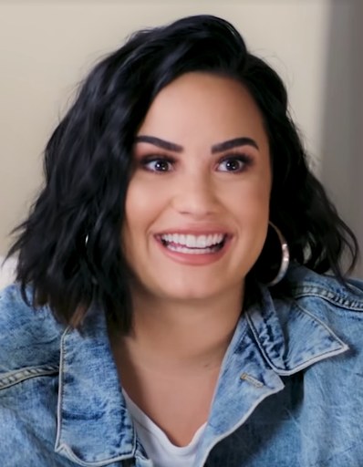 Demi Lovato performing on stage at a concert