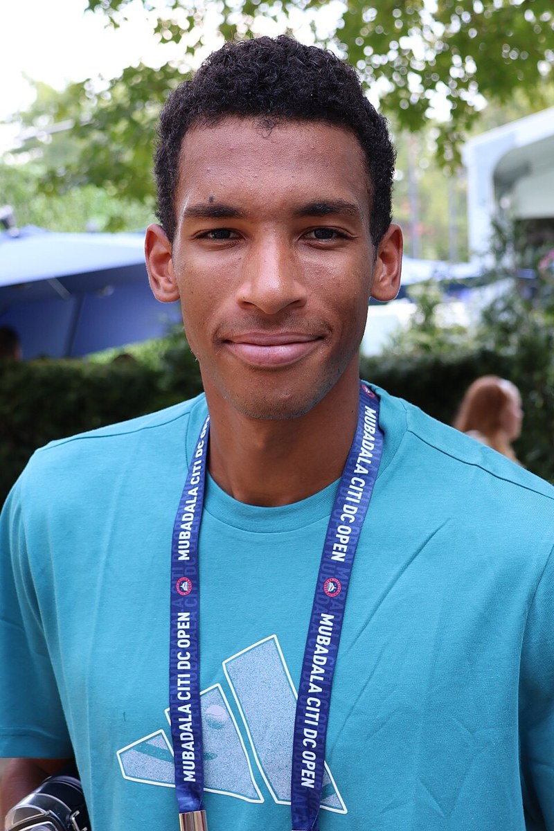 Felix Auger-Aliassime playing tennis at a tournament