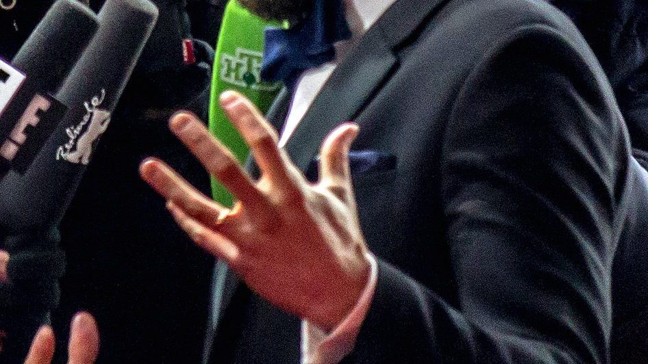 Jamie Dornan smiling on the red carpet in a tailored suit