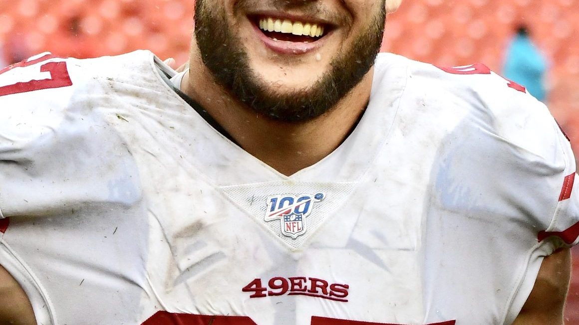 Nick Bosa in San Francisco 49ers uniform celebrating a sack on the field