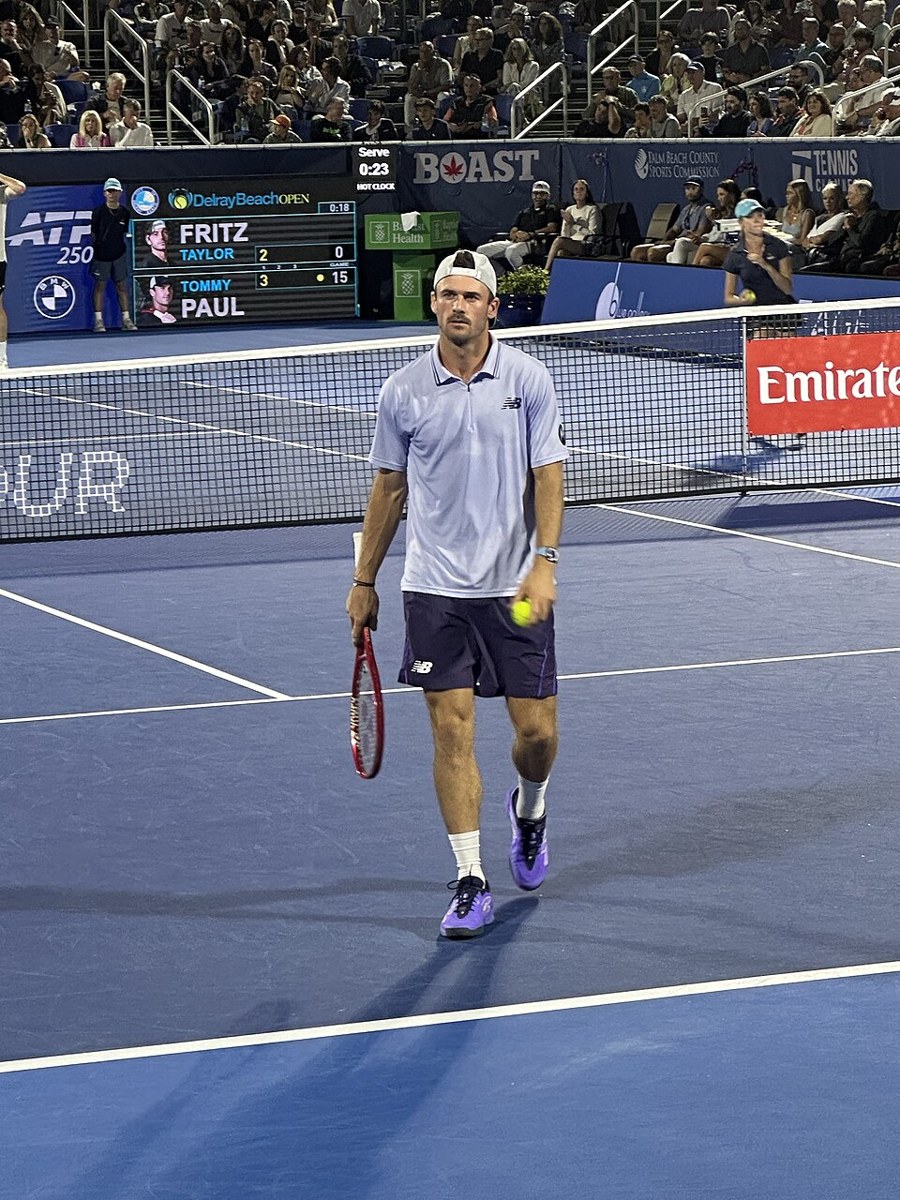 Tommy Paul playing tennis at a Grand Slam tournament