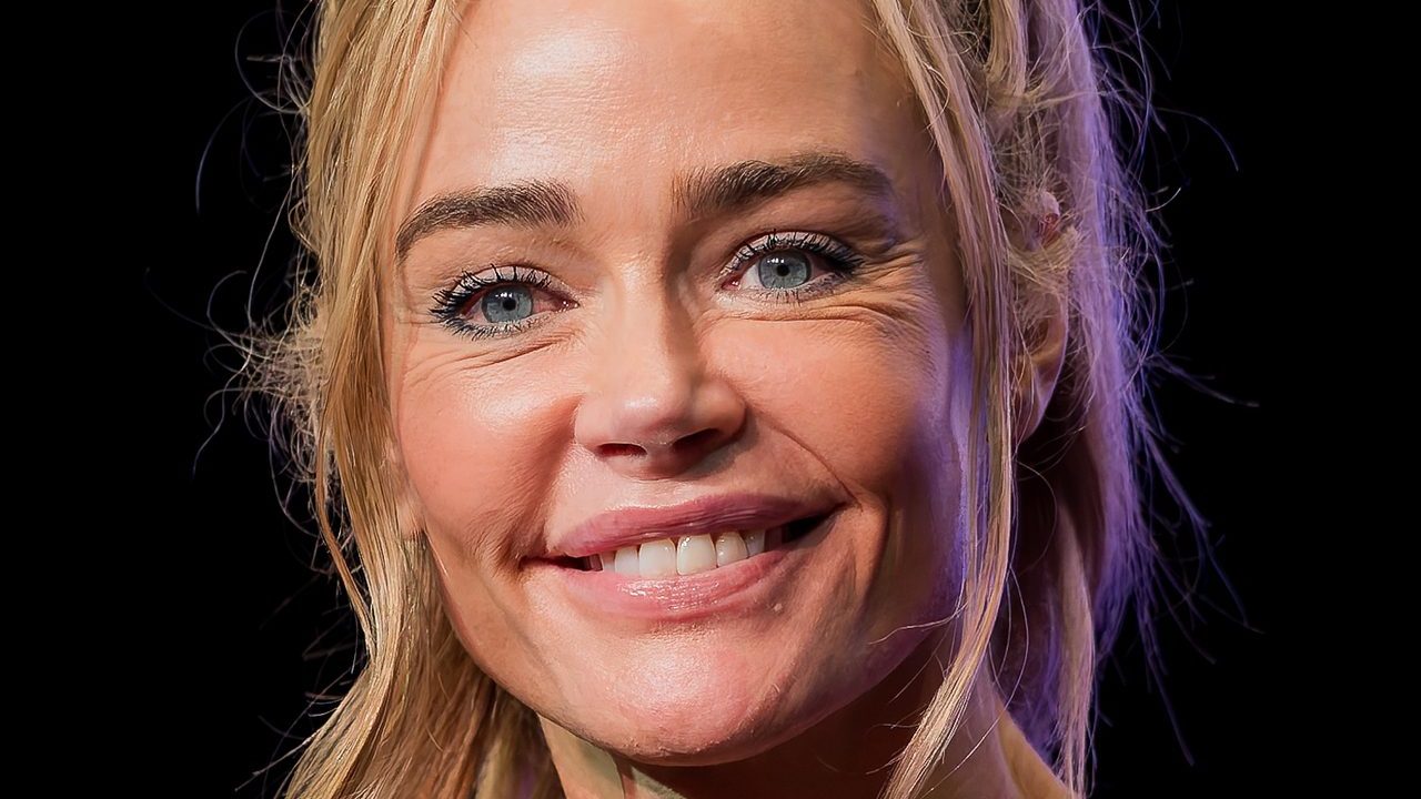 Denise Richards smiling on a red carpet