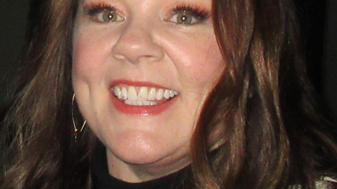 Melissa McCarthy smiling on a red carpet