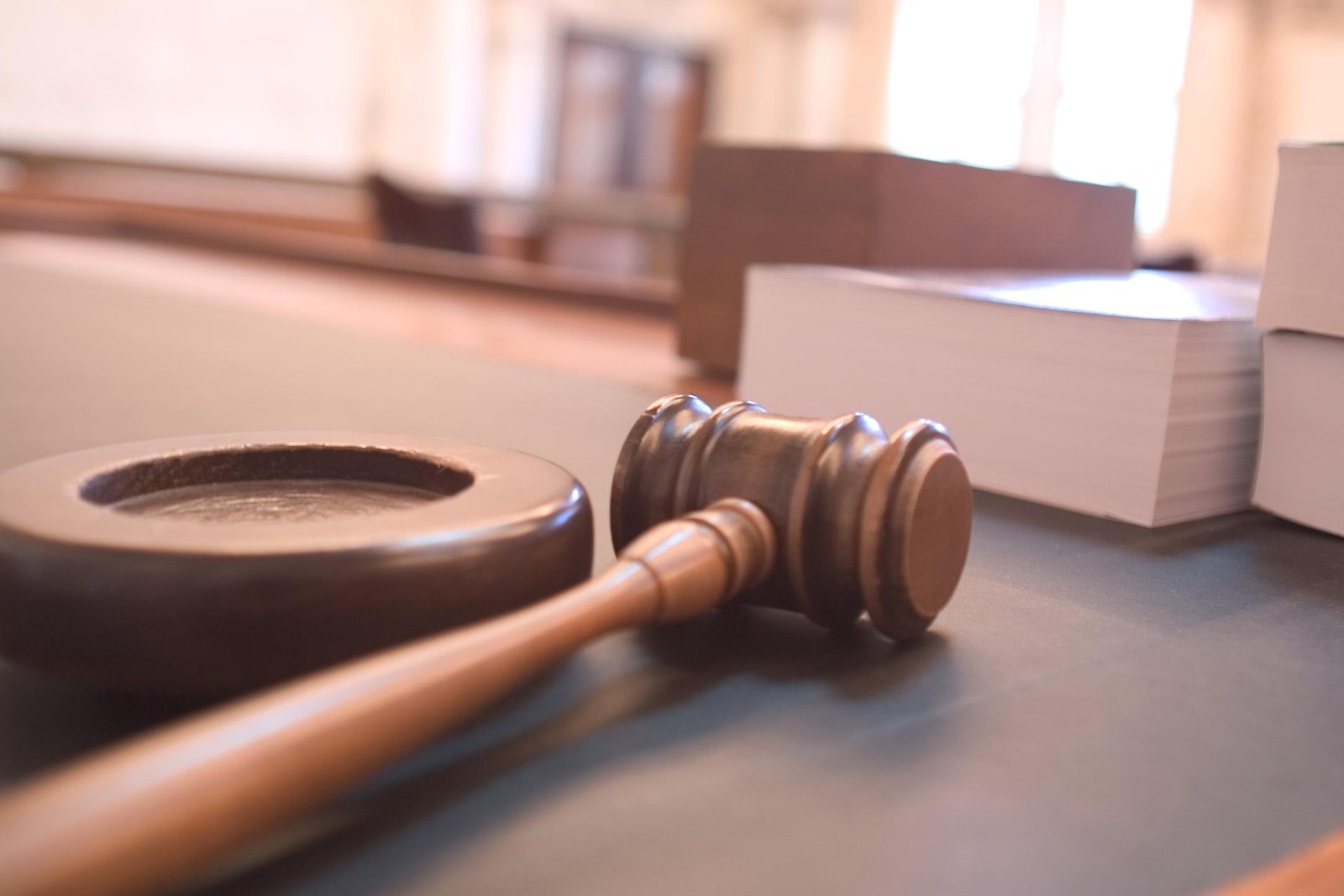 Thematic illustration: a judge's gavel in a courtroom