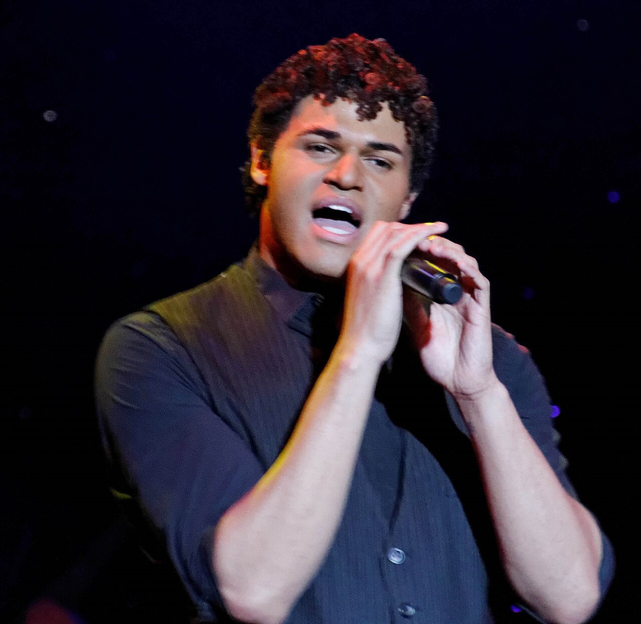 EJay Day performing on a cruise ship stage