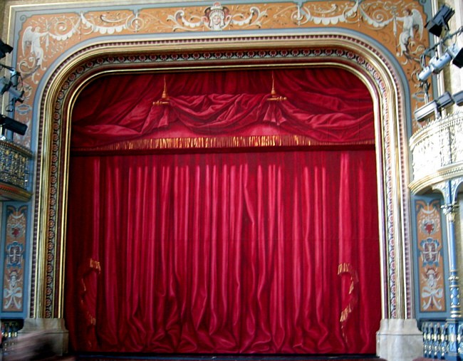 Thematic illustration: a theater stage with curtains