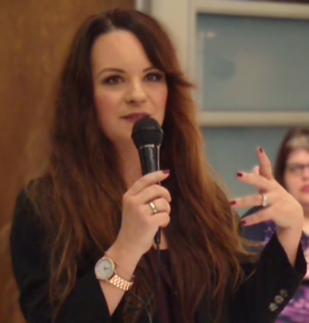 Jenna von Oy speaking at an Armitron event - the former Blossom star now lives in Nashville where she writes and hosts a podcast