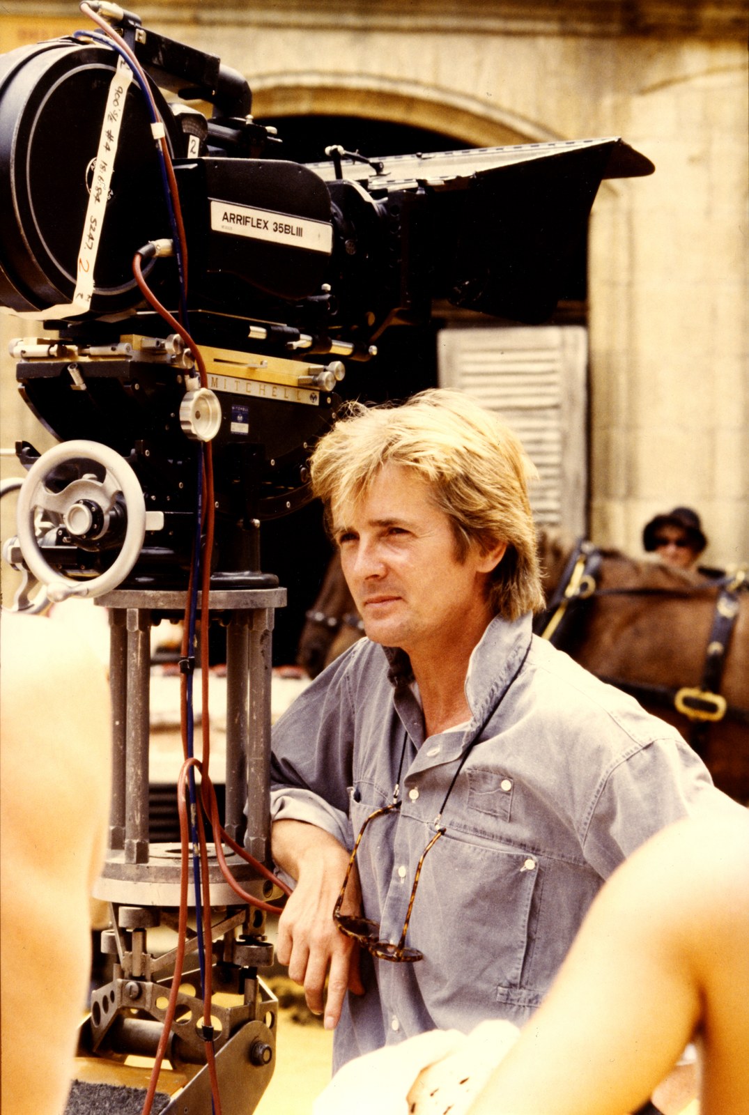 Thematic illustration: a film director with a camera on a movie set
