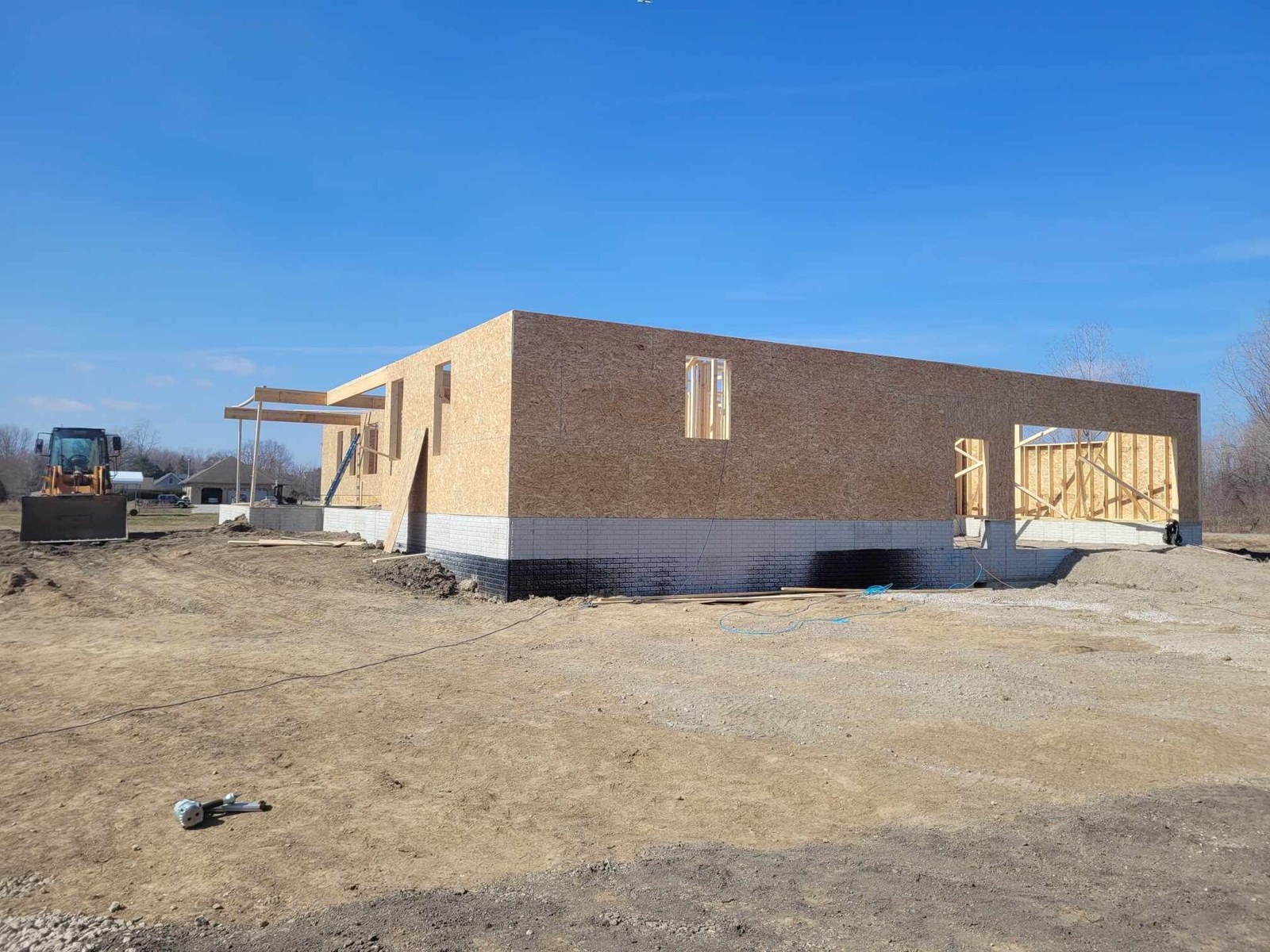Thematic illustration: a house under construction with wooden framing