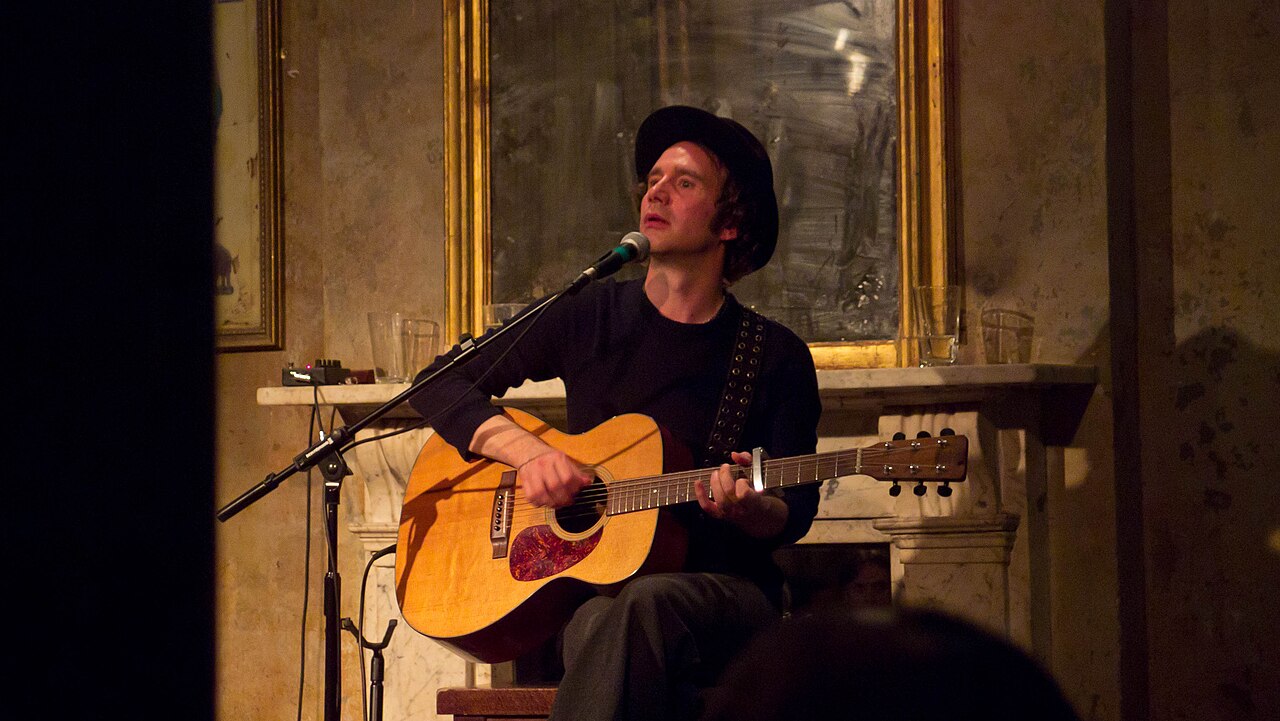 Patrick Duff performing with an acoustic guitar in 2011