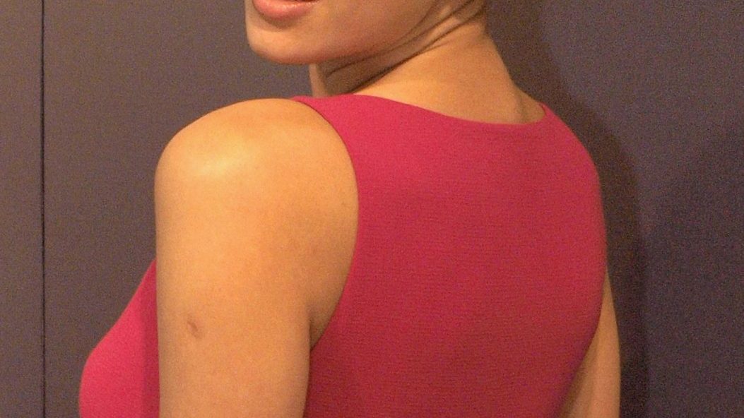 Irina Shayk posing at a fashion event in an elegant gown