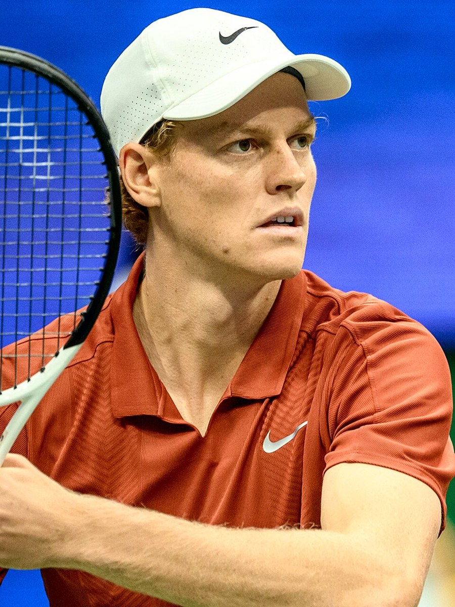 Jannik Sinner playing tennis at a tournament