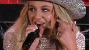 Kelsea Ballerini smiling on a red carpet