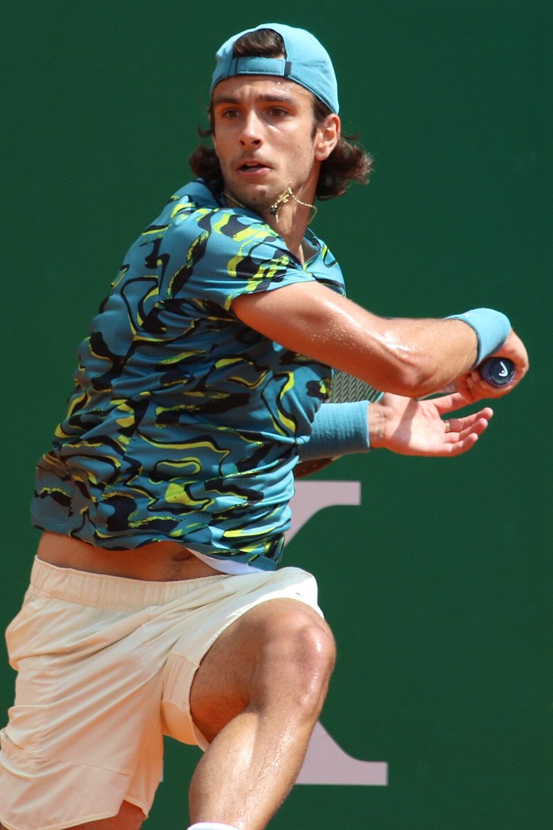 Lorenzo Musetti playing tennis at a tournament